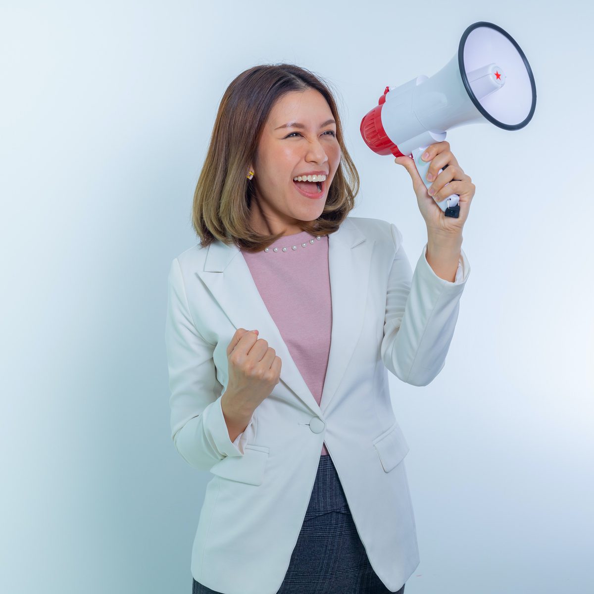 Woman in white blazer holding megaphone