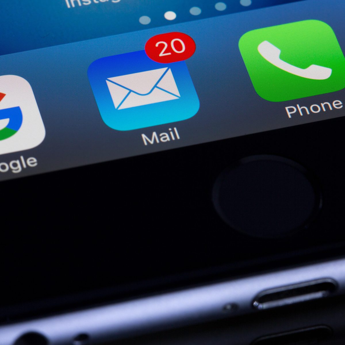 Close-up of smartphone apps including Google, Mail with 20 unread messages, and Phone, showing digital communication tools on a device screen.